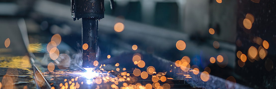 Industrial machinery at work in a manufacturing facility, reflecting the policies and investments supporting a new era of US reindustrialization.